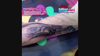 تاتو تفنگ و عقاب روی ساعد دست